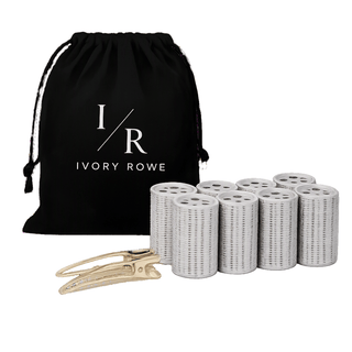 A black drawstring pouch with white 'I/R IVORY ROWE' branding, shown with multiple white cylindrical hair extension rollers and two gold metal clips on a white background.